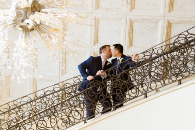 lisa stoner events- luxury wedding planner- orlando wedding planner- same sex weddings- four seasons orlando staircase- grooms kissing.jpg