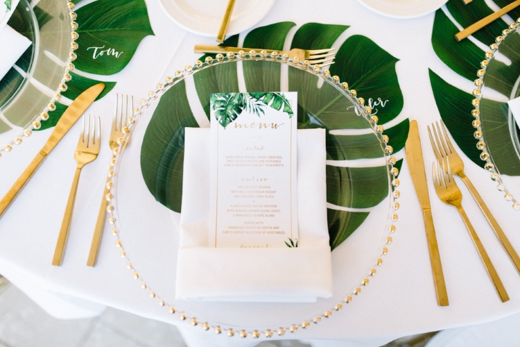 lisa stoner weddings- florida wedding designer- custom wedding menu cards- monstera leaves- gold flatware for a florida wedding- glass charger plate with gold rim.jpg